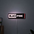 Blackpink LED lightbox hanging on a wall with pink glow