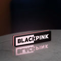 Blackpink LED lightbox standing on a desk from an angled side view with pink glow