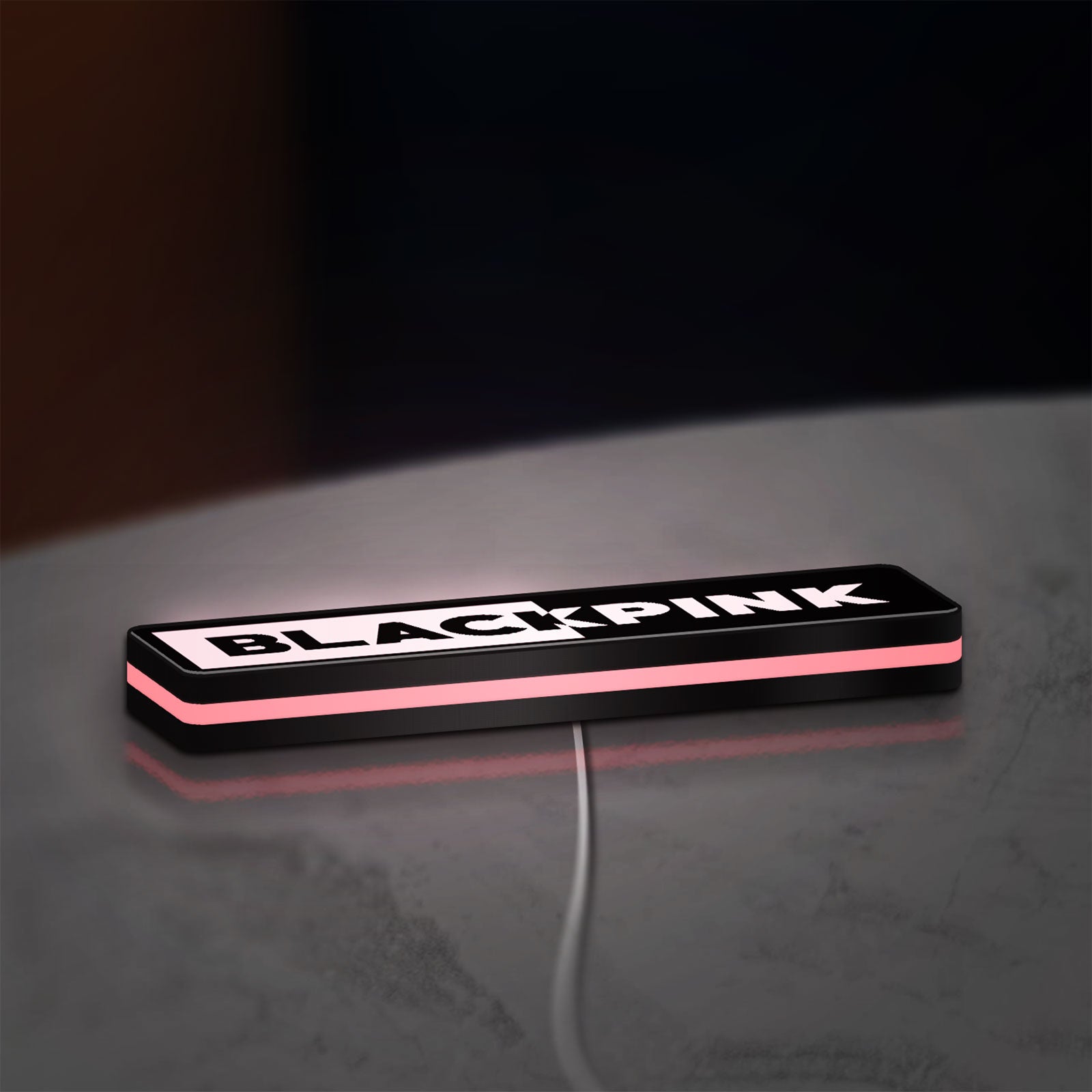 Blackpink LED lightbox lying flat on a desk with pink glow