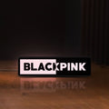 Front view of Blackpink LED lightbox sign glowing on a wooden desk