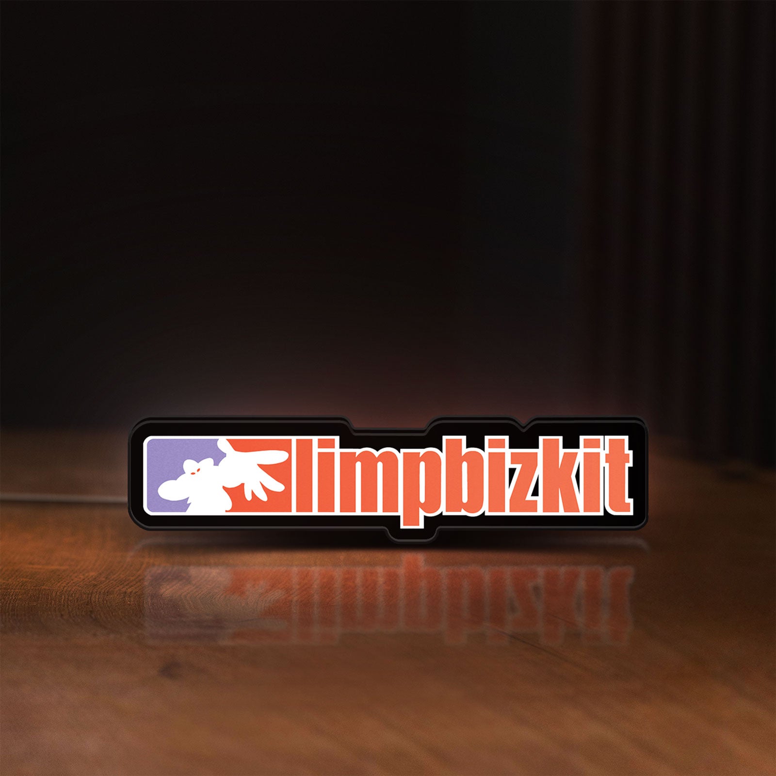Front view of Limp Bizkit LED lightbox sign glowing on a wooden desk