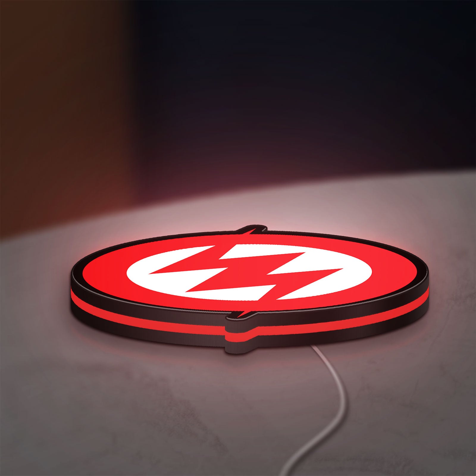 Zoe LED lightbox lying flat on a desk with red glow