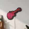 Unlit The Monkees Guitar LED lightbox mounted on a wall in daylight