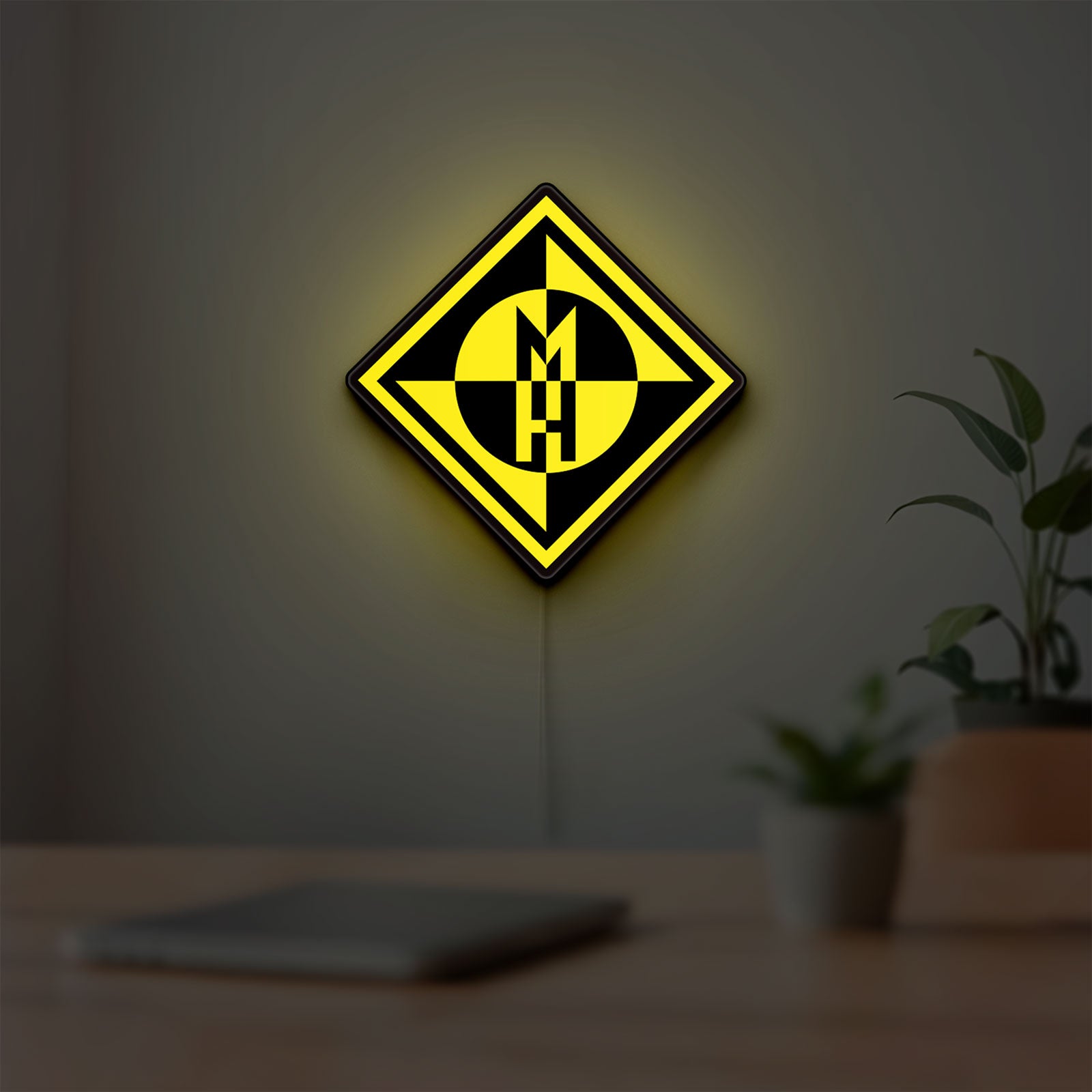 Machine Head LED lightbox hanging on a room wall with soft yellow light