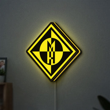 Machine Head LED lightbox hanging on a wall with yellow glow