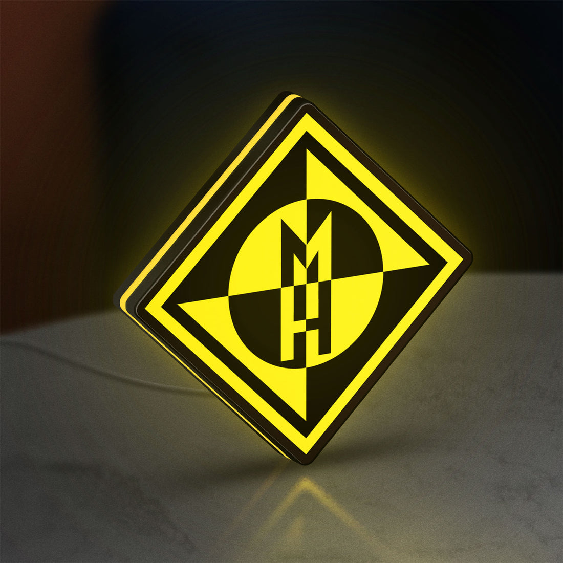 Machine Head LED lightbox hanging on a wall with yellow glow