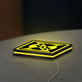 Machine Head LED lightbox lying flat on a desk with yellow glow