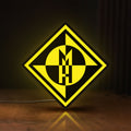 Front view of Machine Head LED lightbox sign glowing on a wooden desk
