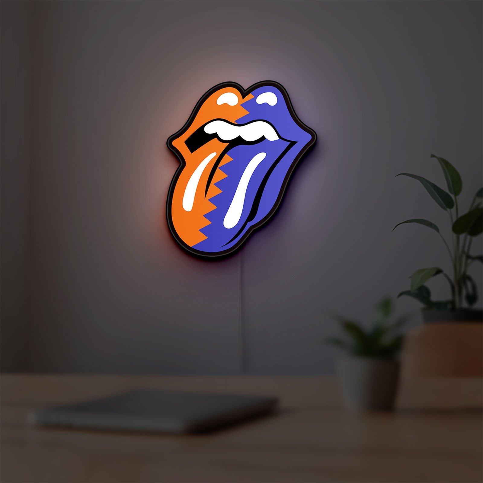 Rolling Stones LED lightbox hanging on a room wall with soft red light
