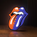 Front view of Rolling Stones LED lightbox sign glowing on a wooden desk