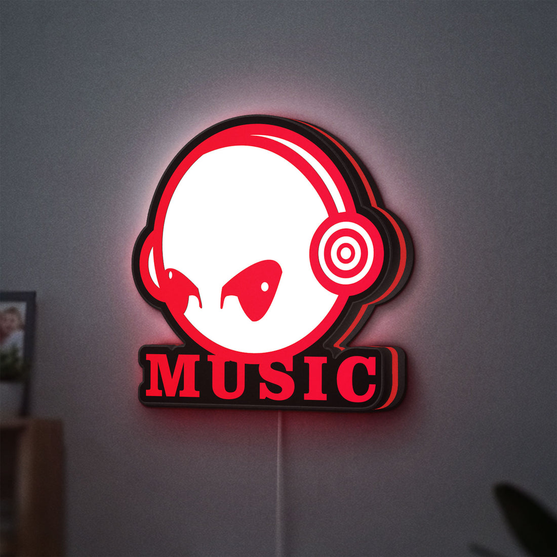 Custom Music LED lightbox hanging on a wall with red glow