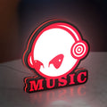 Custom Music LED lightbox standing on a desk from an angled side view with red glow