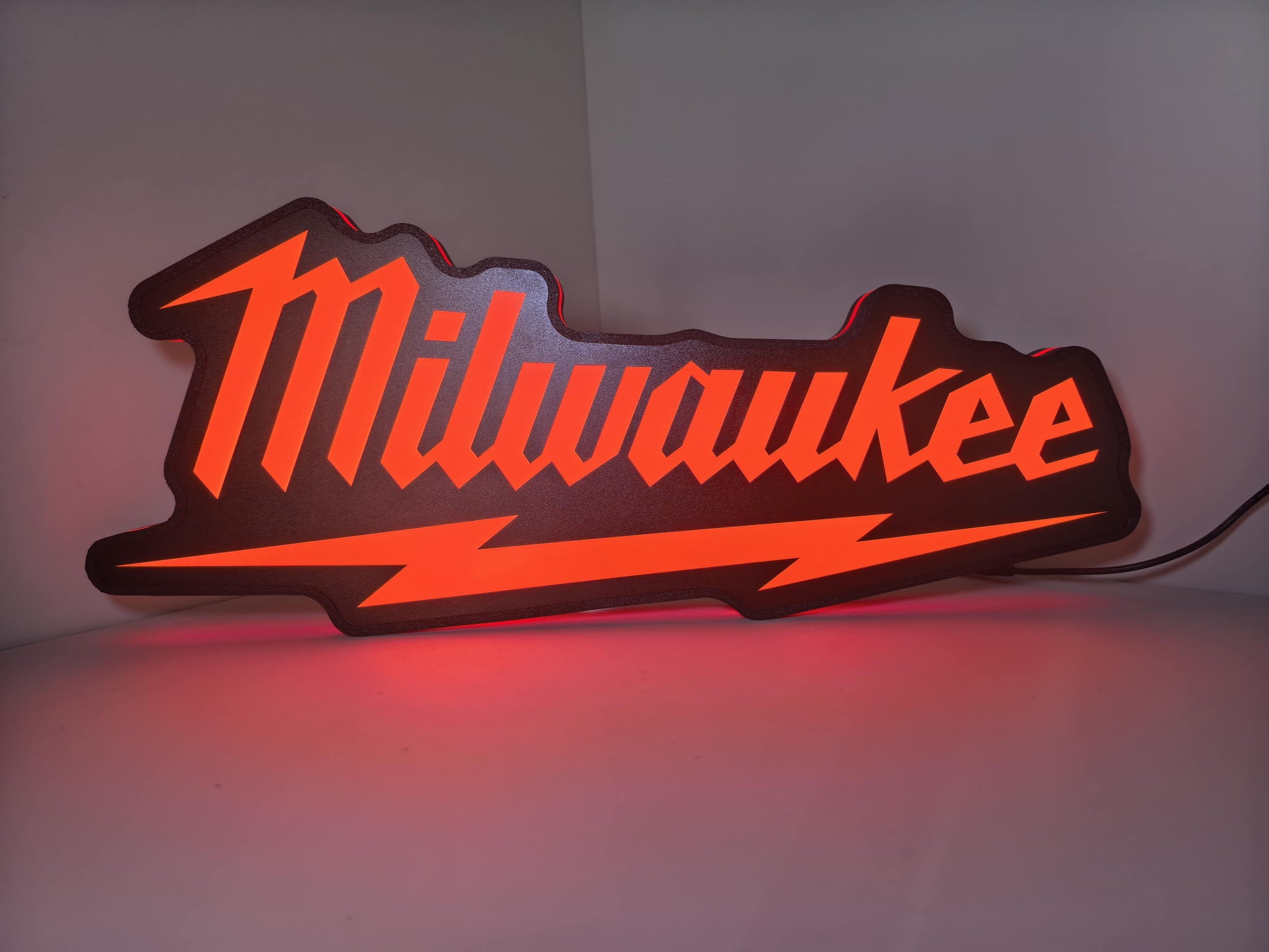 Illuminated front view standing of Milwaukee Play Button Illuminated Sign in 50cm, perfect for garage and man cave decor