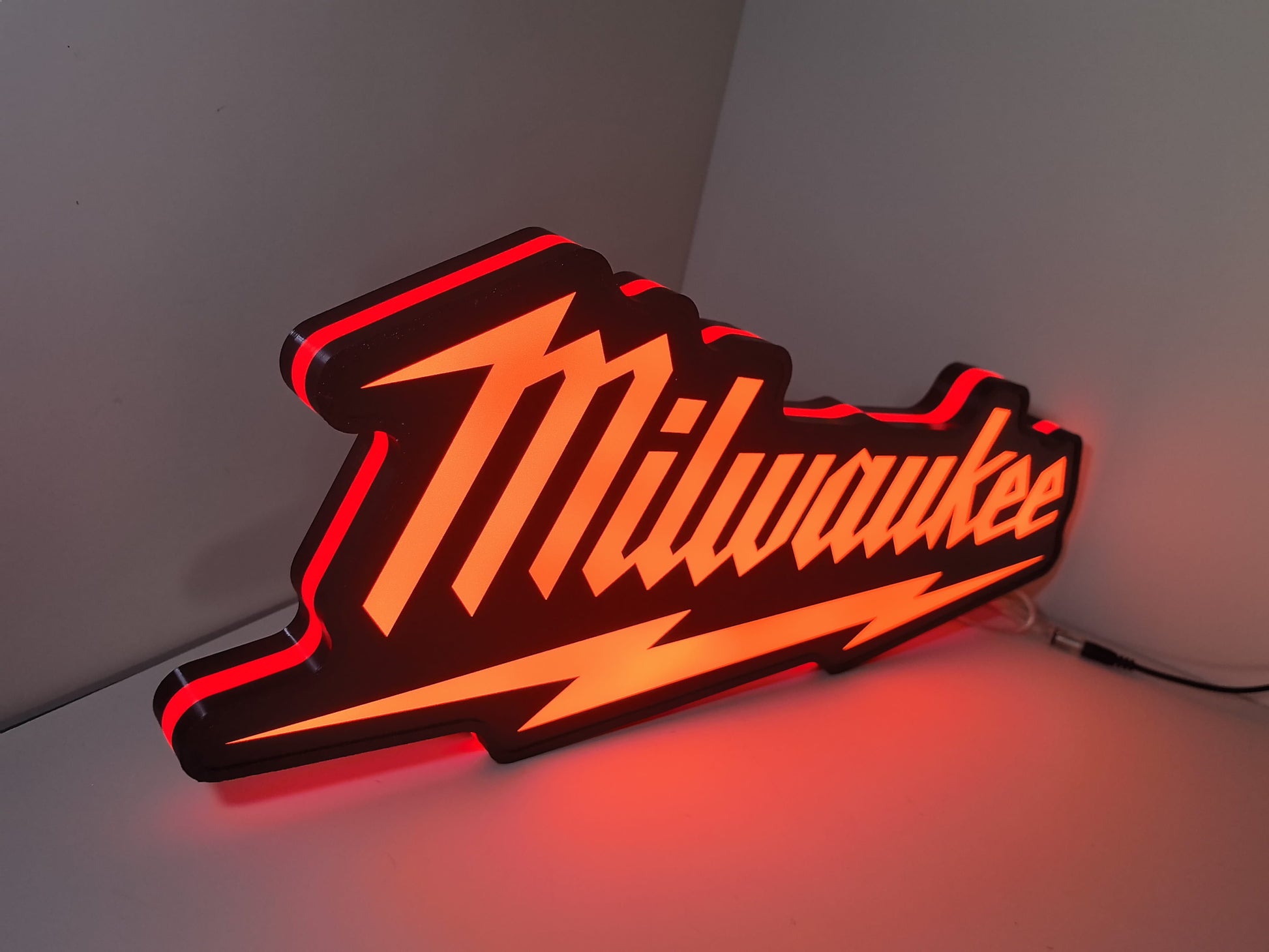 Milwaukee Play Button LED Light Box (50cm) - Illuminated angled view standing, perfect for garage and man cave decor