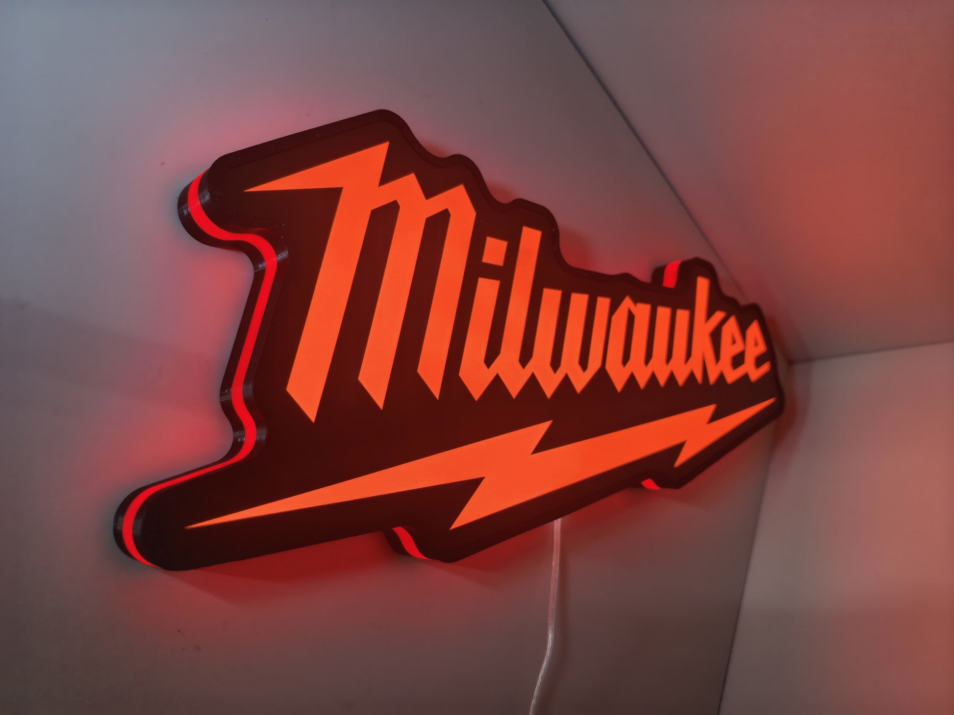 Milwaukee Play Button 3D LED Sign (50cm) - Illuminated flat lay angled view, perfect for garage and man cave decor