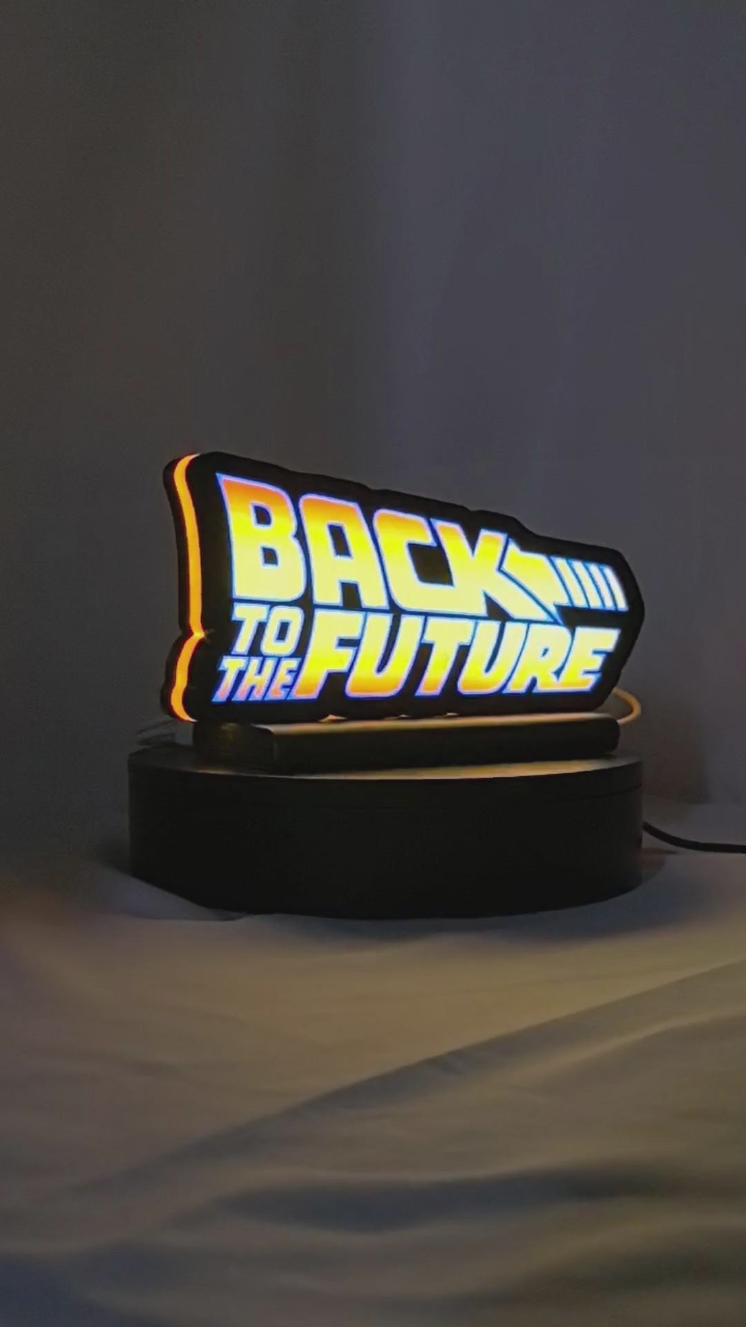 Product video showcase of Back To The Future Delorean 3D LED Sign, demonstrating unlit and illuminated lighting effects with a 360-degree rotating view, unique wall art for desk and room decor.