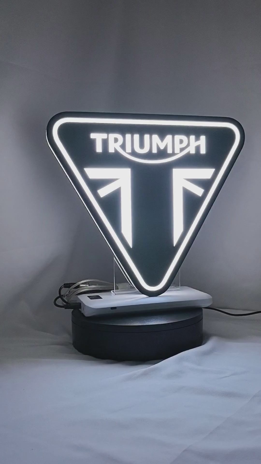 Product video showcase of Triumph Motorcycles 3D LED Sign, demonstrating unlit and illuminated lighting effects with a 360-degree rotating view, perfect for garage and man cave decor.