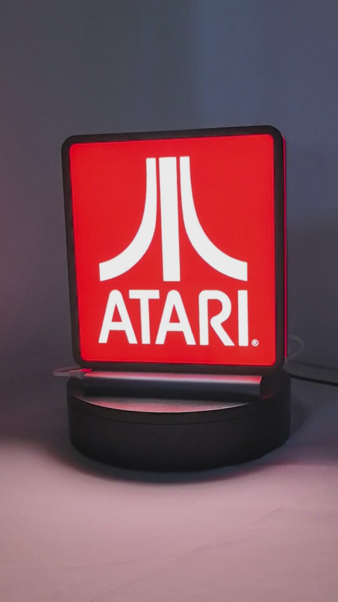 Product video showcase of Atari 3D LED Sign, demonstrating unlit and illuminated lighting effects with a 360-degree rotating view, unique wall art for desk and room decor.