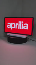 Product video showcase of Aprilia Dimmable 3D LED Sign, demonstrating unlit and illuminated lighting effects with a 360-degree rotating view, unique wall art for desk and room decor.