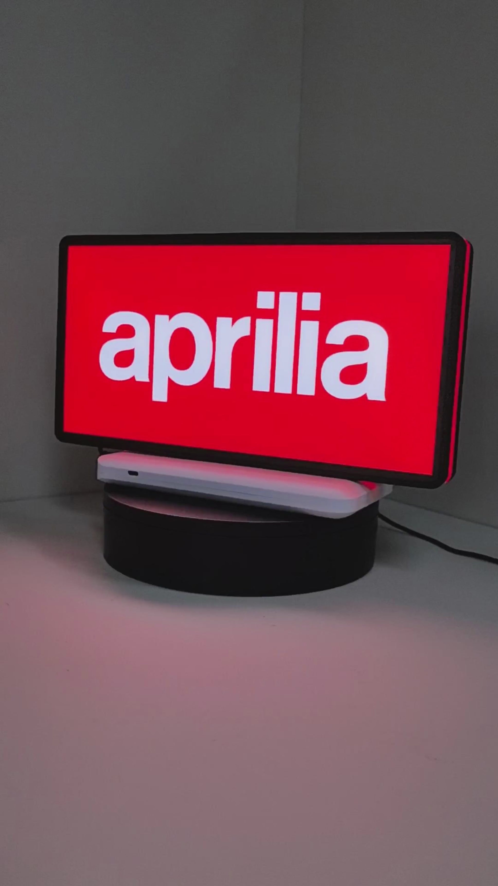 Product video showcase of Aprilia Dimmable 3D LED Sign, demonstrating unlit and illuminated lighting effects with a 360-degree rotating view, unique wall art for desk and room decor.