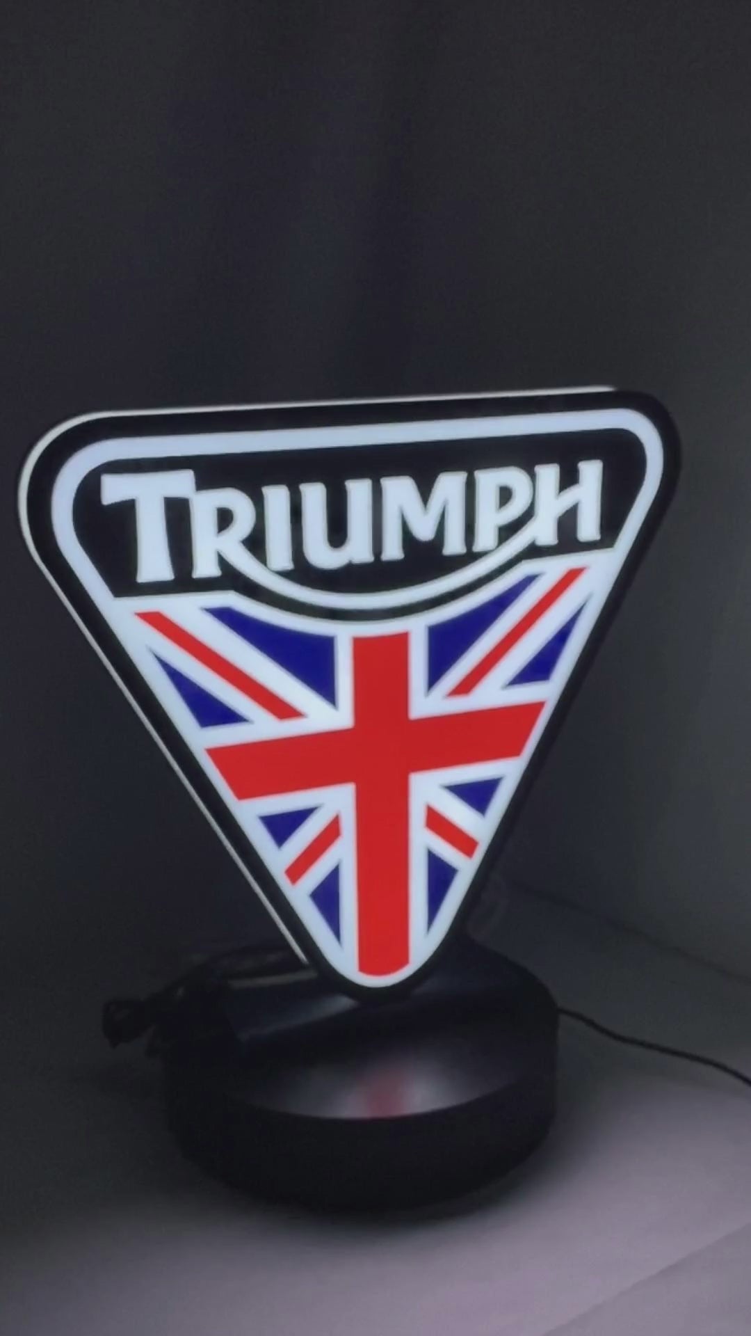 Product video showcase of Triumph 3D LED Sign, demonstrating unlit and illuminated lighting effects with a 360-degree rotating view, perfect for garage and man cave decor.