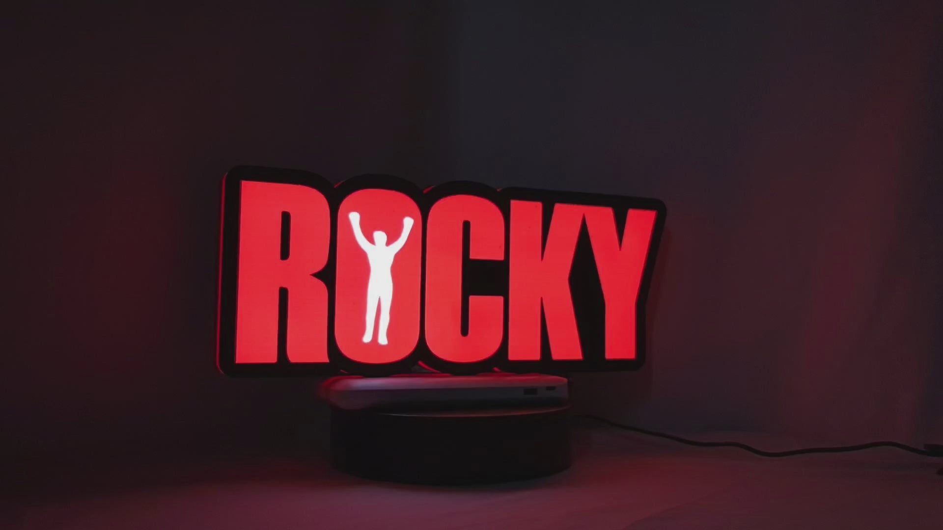 Product video showcase of Rocky Balboa 3D LED Sign, demonstrating unlit and illuminated lighting effects with a 360-degree rotating view, perfect for music studio and bedroom decor.