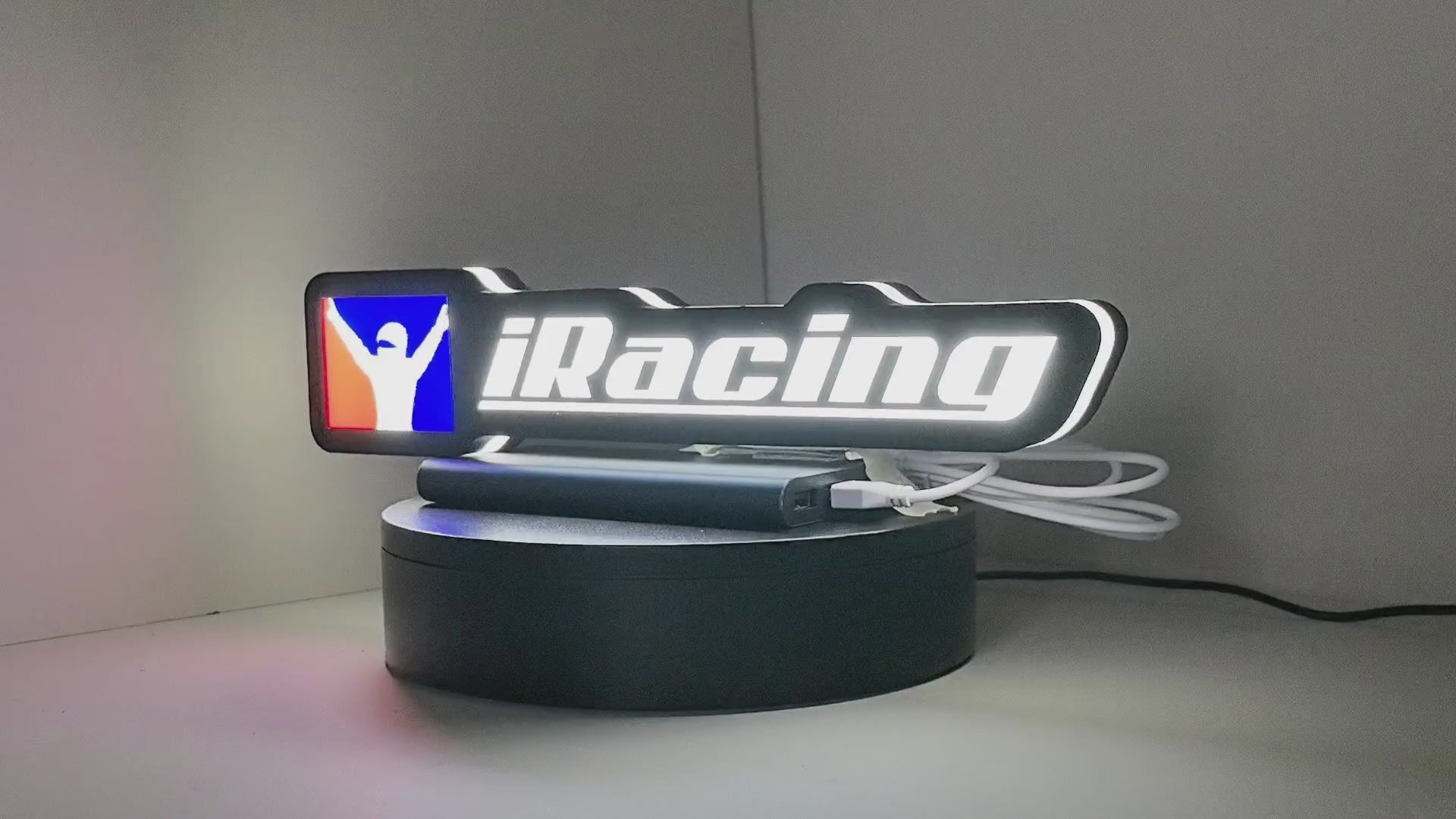 Product video showcase of Iracing 3D LED Sign, demonstrating unlit and illuminated lighting effects with a 360-degree rotating view, perfect for garage and man cave decor.