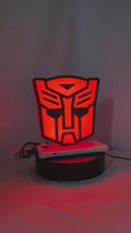 Product video showcase of Autobot 3D LED Sign, demonstrating unlit and illuminated lighting effects with a 360-degree rotating view, perfect for garage and man cave decor.