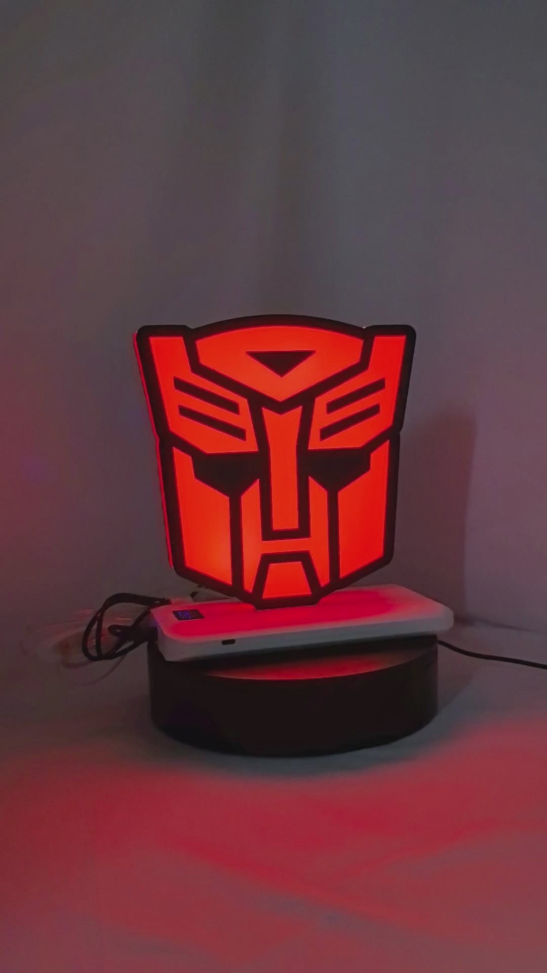Product video showcase of Autobot 3D LED Sign, demonstrating unlit and illuminated lighting effects with a 360-degree rotating view, perfect for garage and man cave decor.