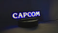 Product video showcase of Capcom 3D LED Sign, demonstrating unlit and illuminated lighting effects with a 360-degree rotating view, unique wall art for desk and room decor.