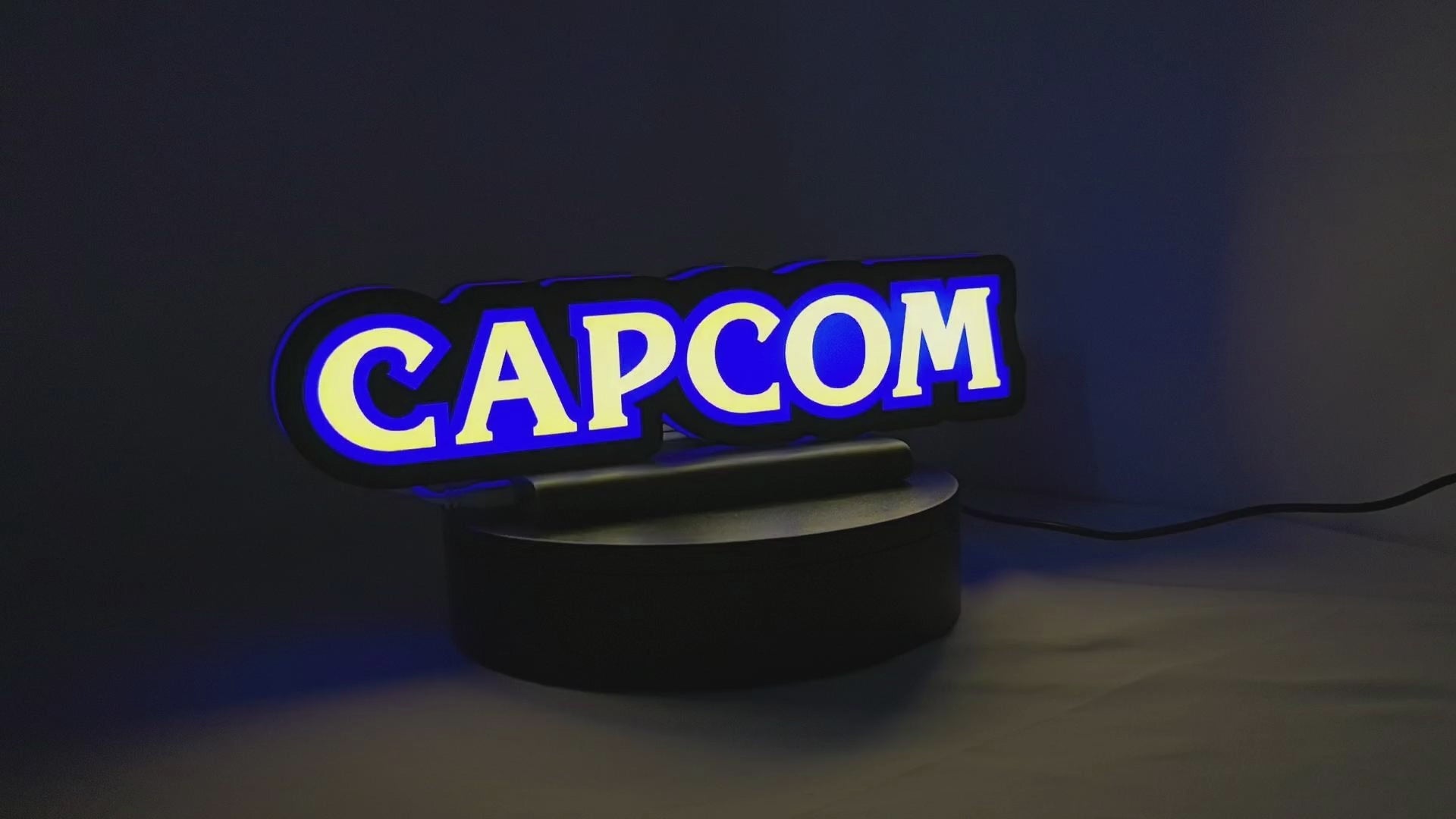 Product video showcase of Capcom 3D LED Sign, demonstrating unlit and illuminated lighting effects with a 360-degree rotating view, unique wall art for desk and room decor.