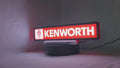 Product video showcase of Kenworth 3D LED Sign, demonstrating unlit and illuminated lighting effects with a 360-degree rotating view, perfect for garage and man cave decor.