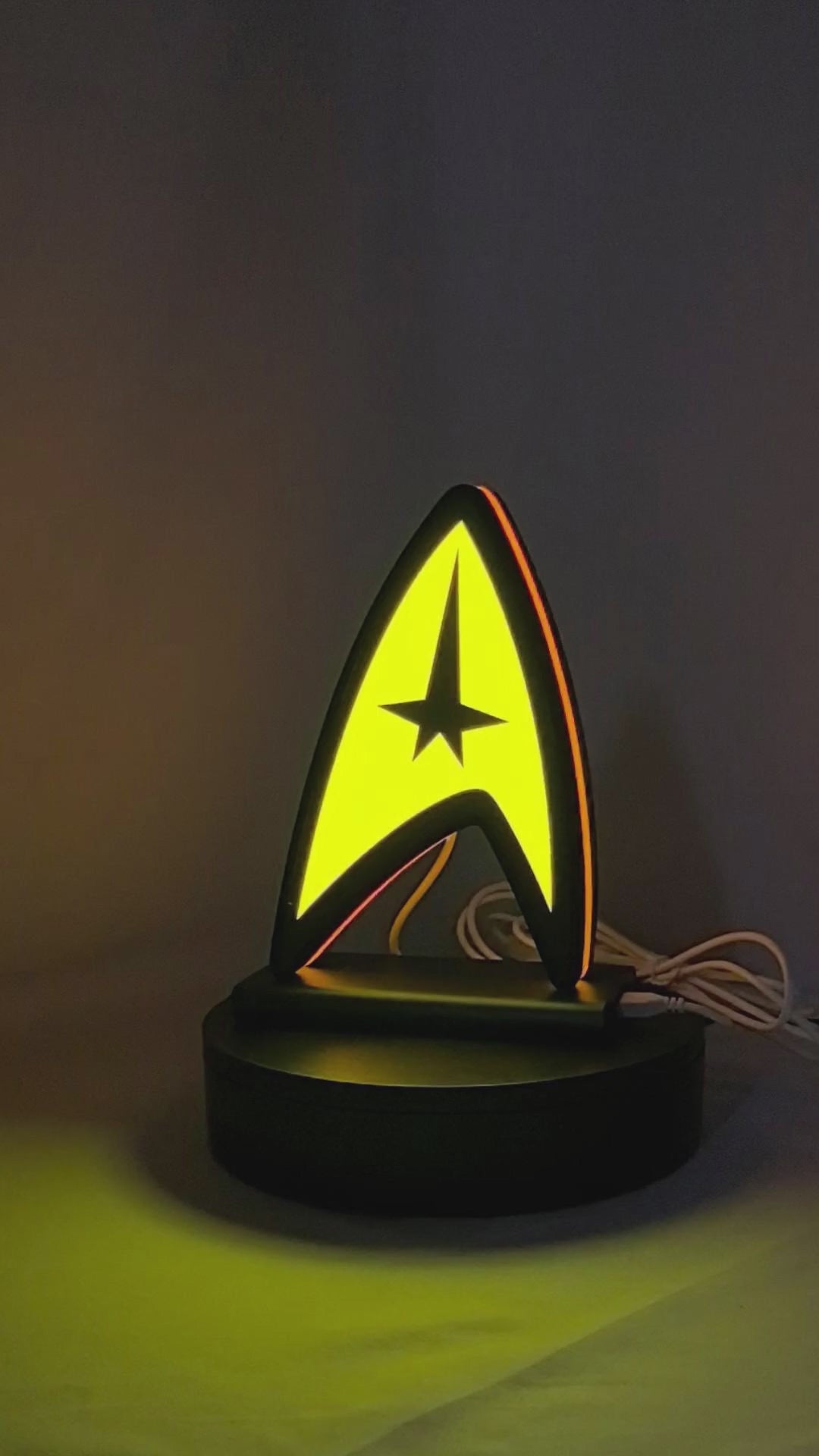 Product video showcase of Star Trek Command Insignia 3D LED Sign, demonstrating unlit and illuminated lighting effects with a 360-degree rotating view, unique wall art for desk and room decor.