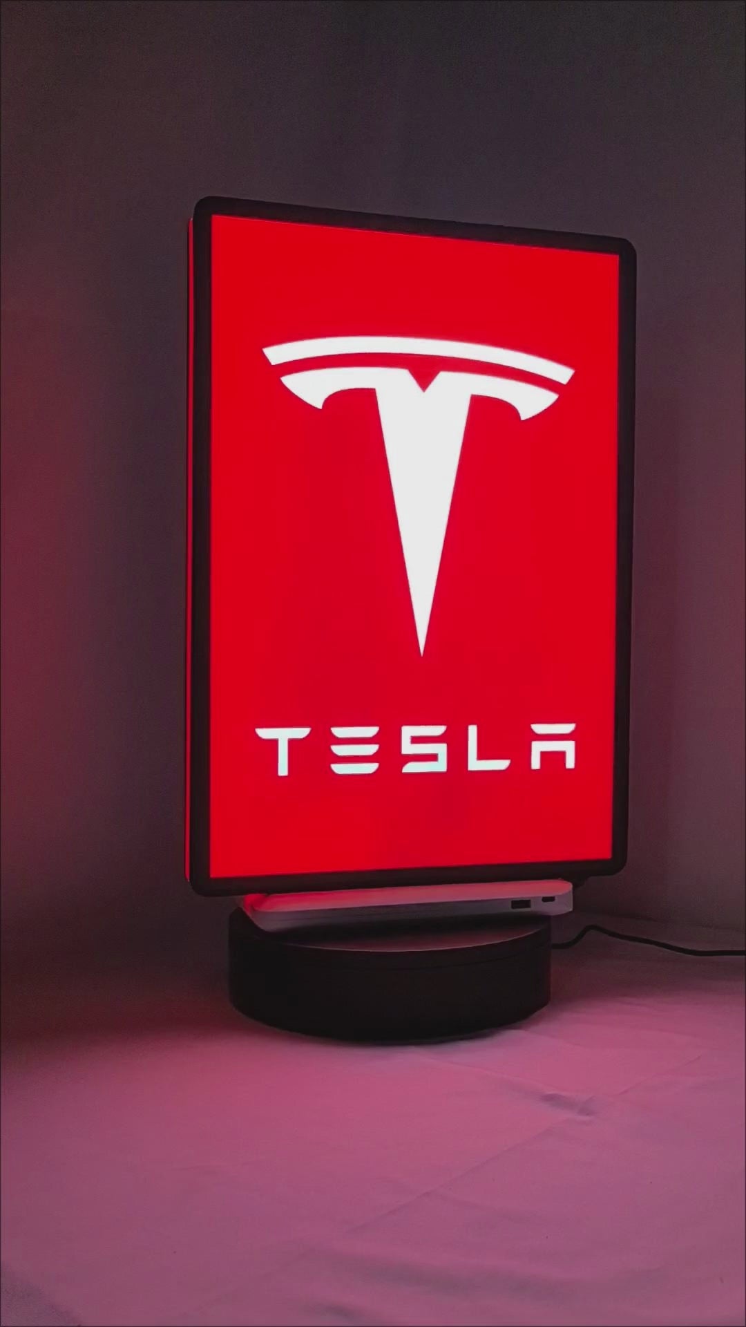 Product video showcase of Tesla 3D LED Sign, demonstrating unlit and illuminated lighting effects with a 360-degree rotating view, perfect for garage and man cave decor.