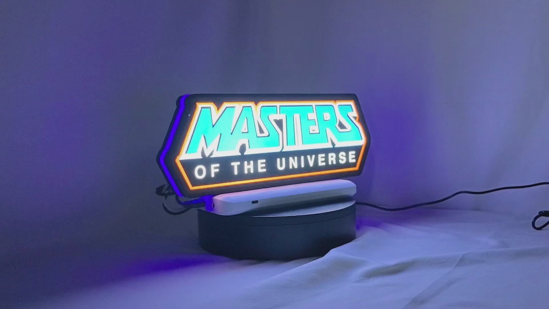 Product video showcase of Masters Of The Universe 3D LED Sign, demonstrating unlit and illuminated lighting effects with a 360-degree rotating view, unique wall art for desk and room decor.